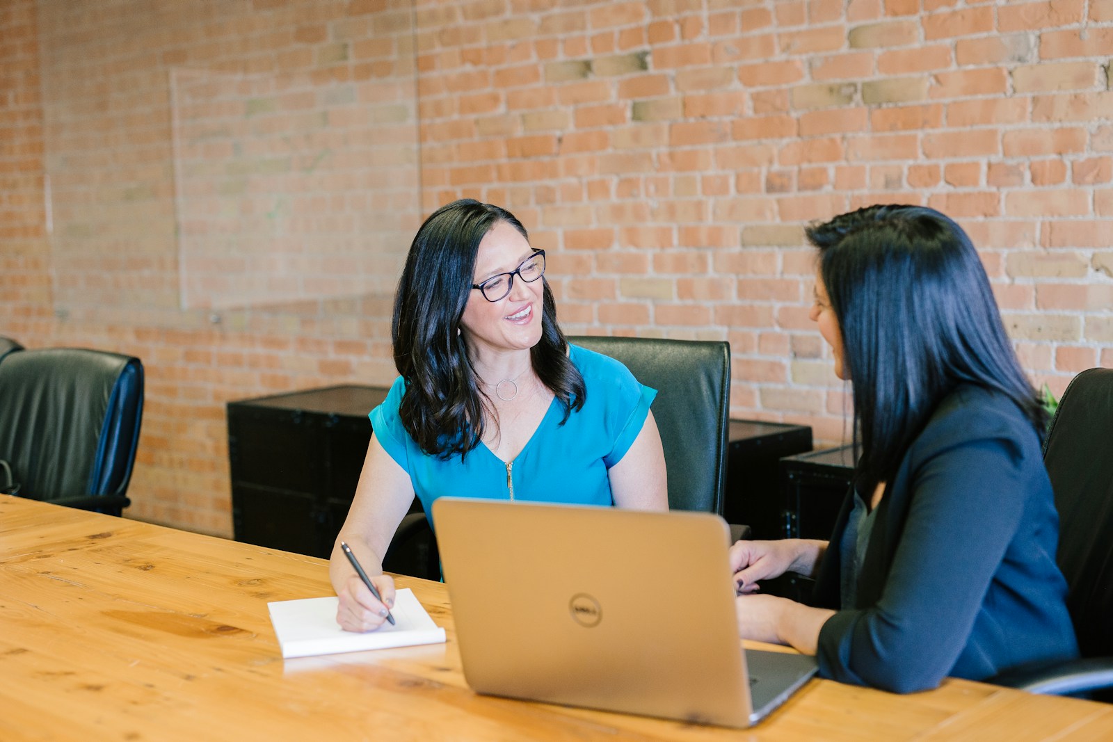 A financial adviser meeting with a client across a conference table